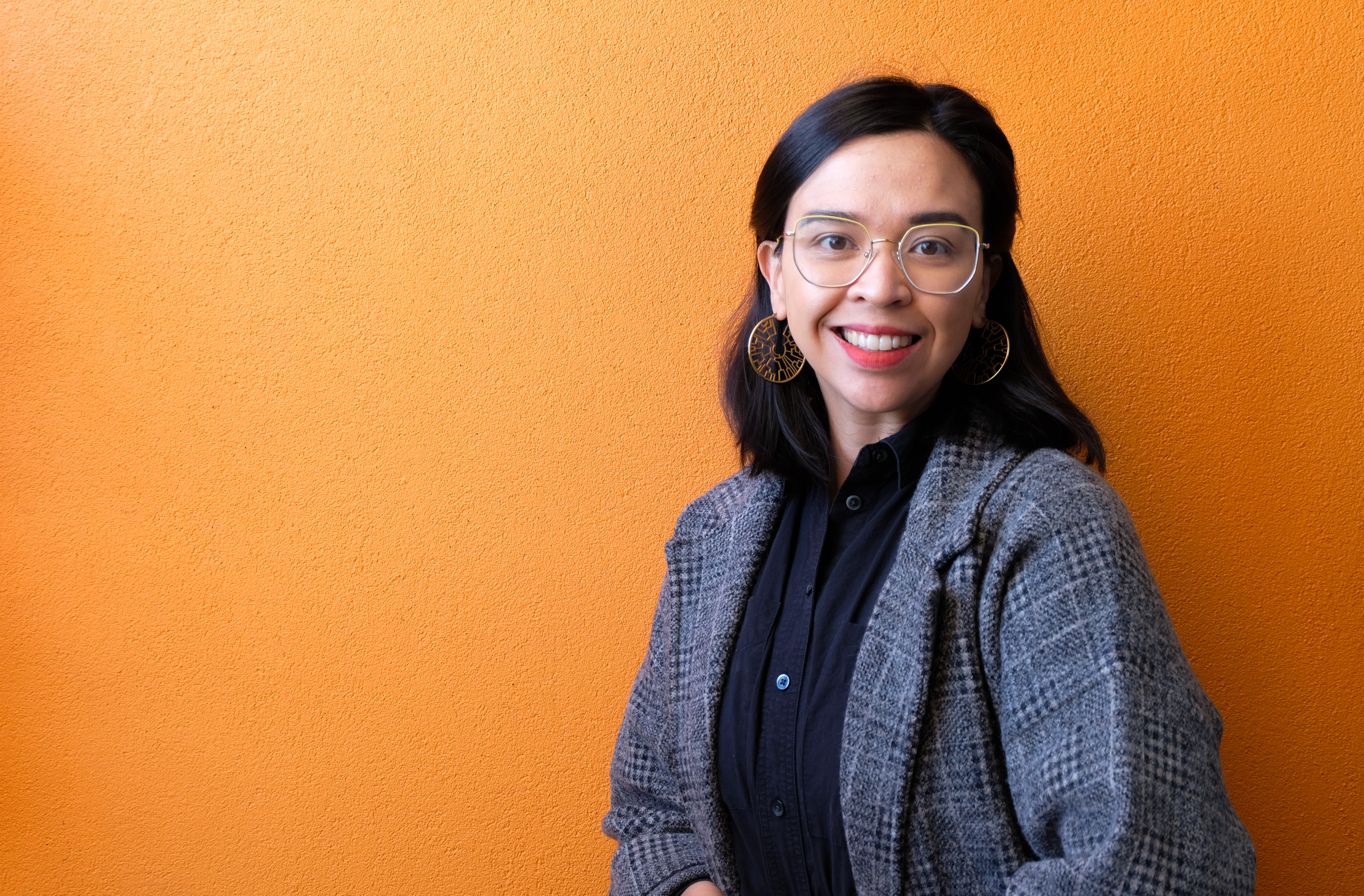 profile of Stephanie Wilson in front of an orange background